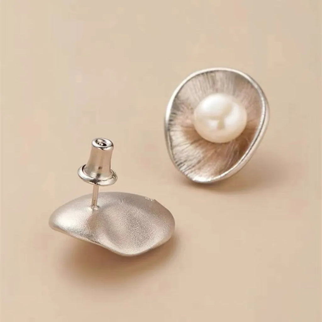 Pearl sterling silver needle earrings with geometric design and gold electroplated finish