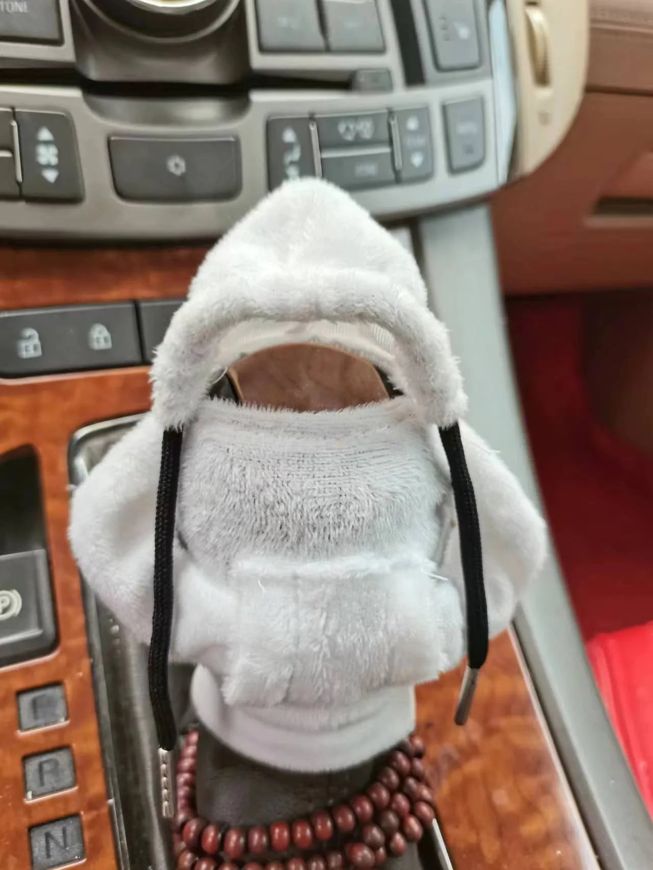 Dutch velvet car gear handle sleeve cover in multiple colours on a car gear lever.