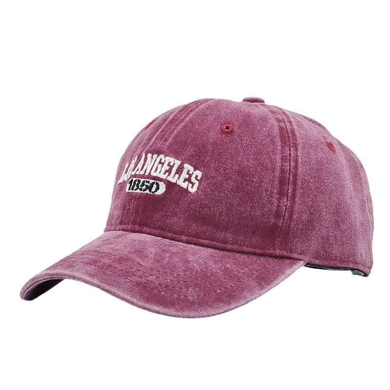 Retro personalised distressed embroidered peaked cap in beige colour with adjustable strap and conical crown.