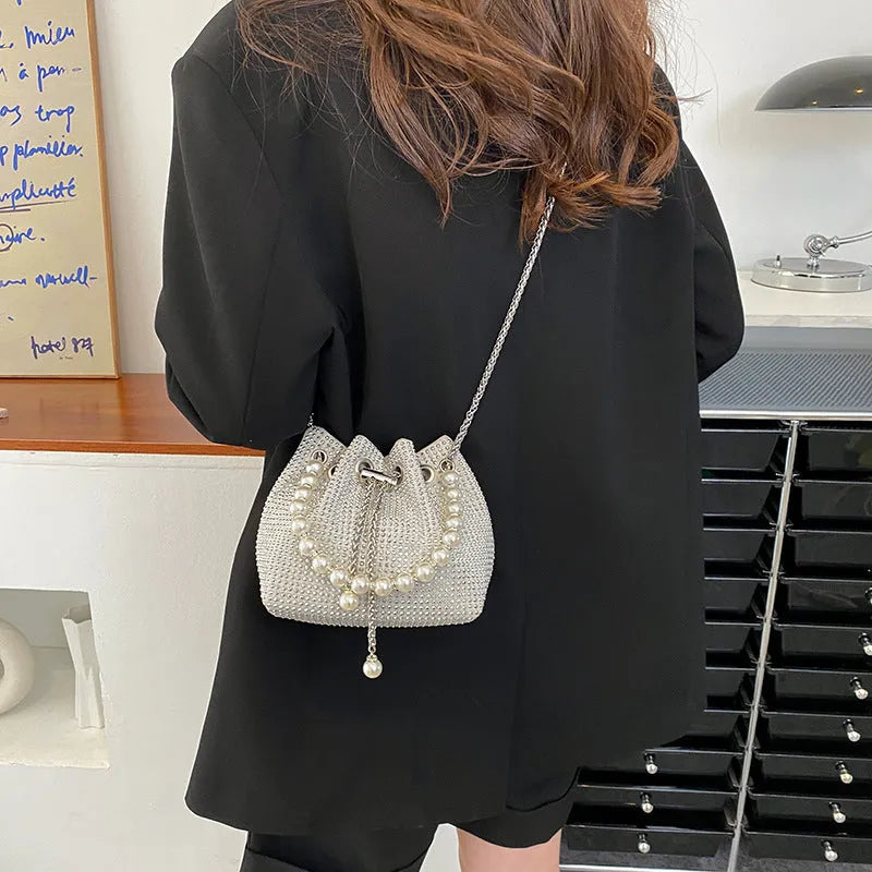 Diamond pattern women's crossbody bag in PU leather with metal chain strap, showing internal phone pocket and change purse.