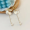 Women's acrylic earrings with pearl and shell tassel design measuring 8.8cm length