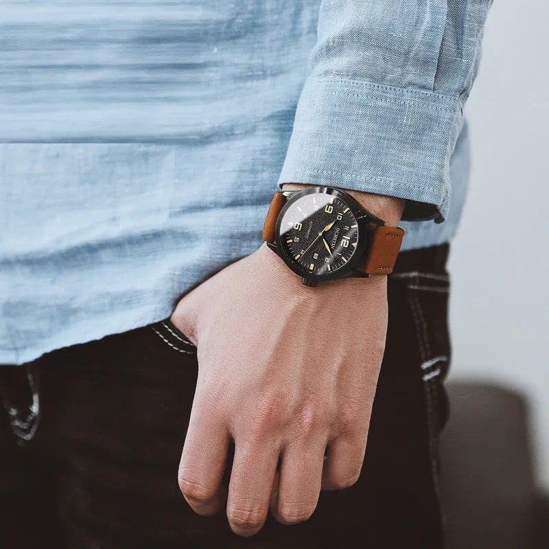 Men's black and silver automatic mechanical watch with leather strap showing 12mm thickness