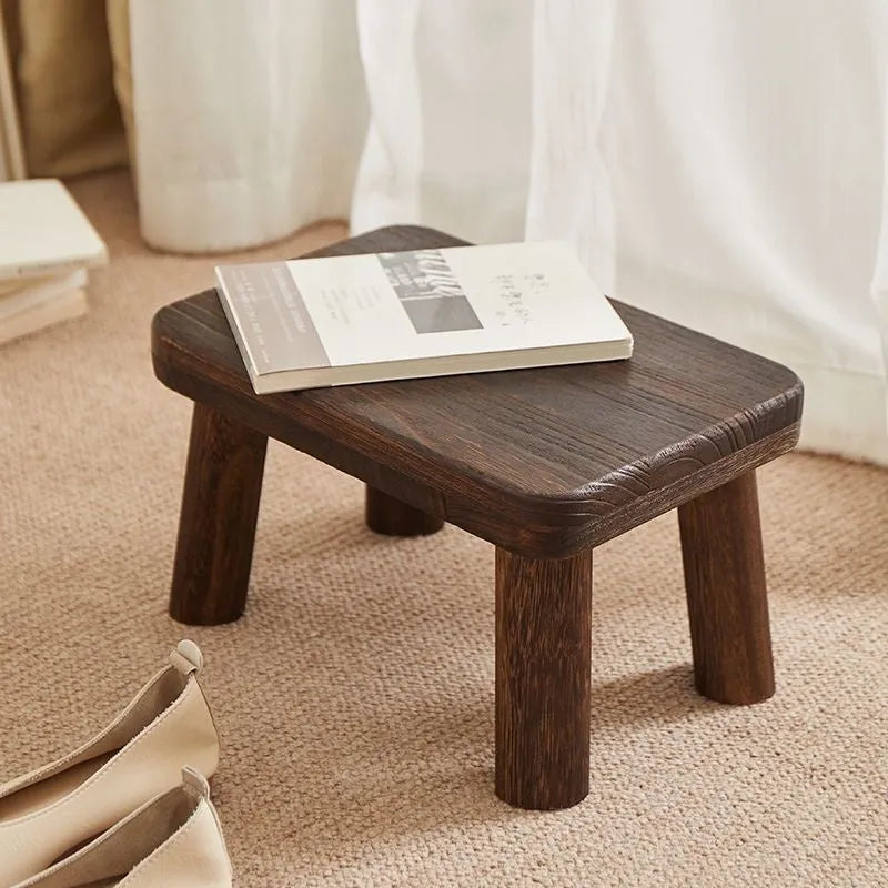 Distressed solid wood household stool with a bracket structure frame for shoe changing.