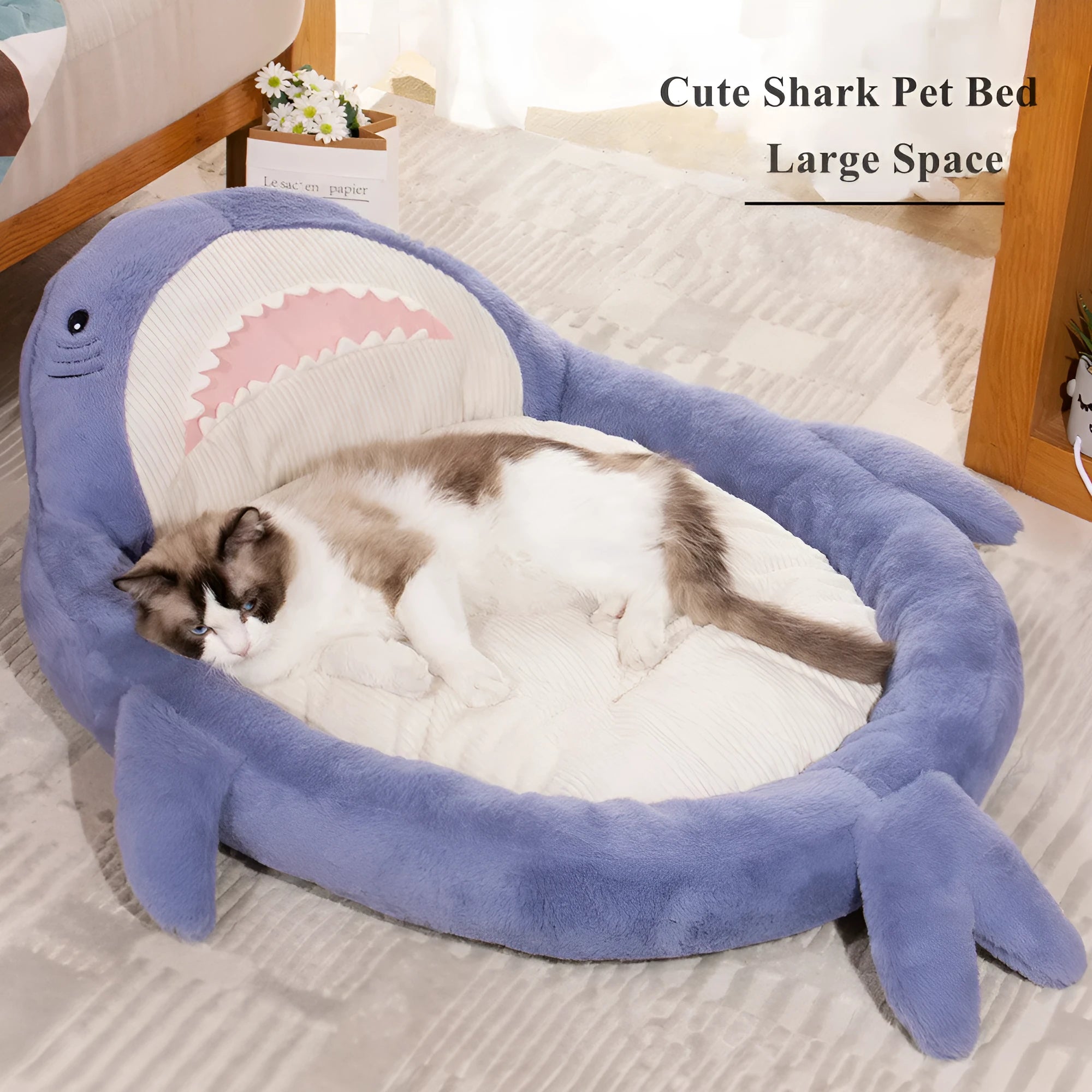 Blue shark pattern pet bed cushion on a floor, showing soft velvet material and non-slip base.