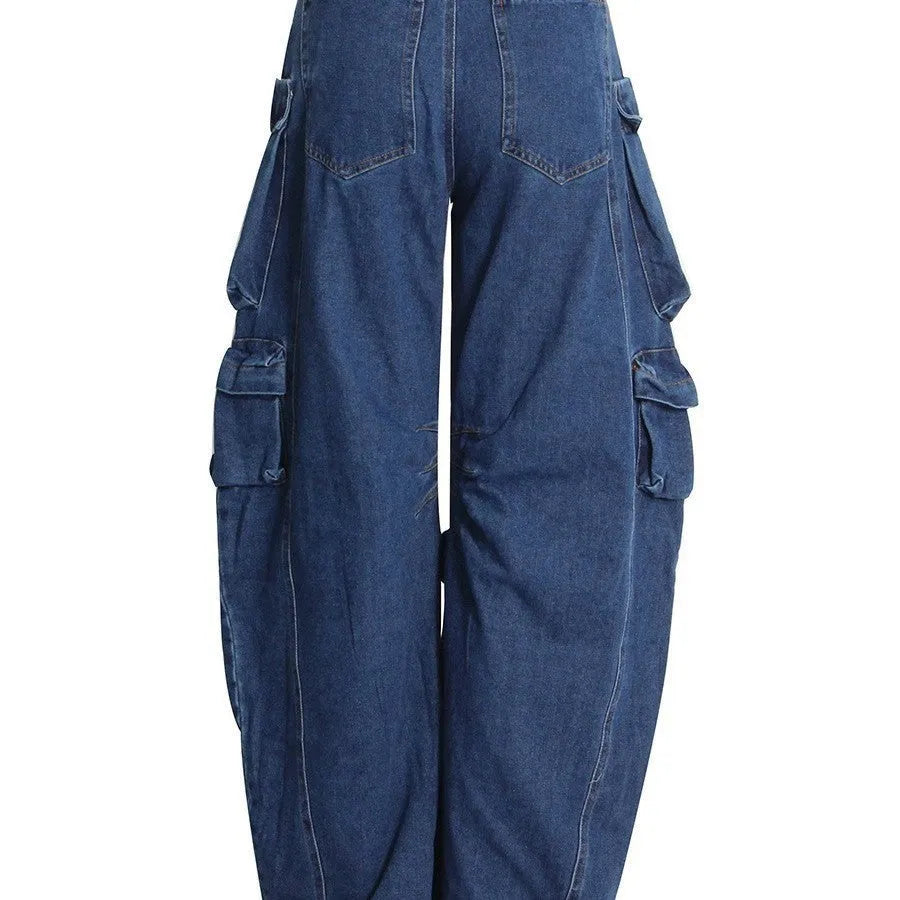 Dark blue distressed wide-leg high-waist jeans with multiple pockets on a denim background.
