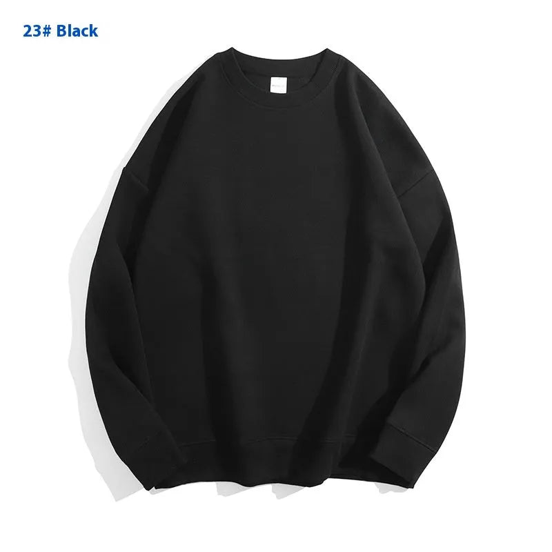 A loose-fitting, off-shoulder cotton sweater in a solid colour with long sleeves and a round neck.