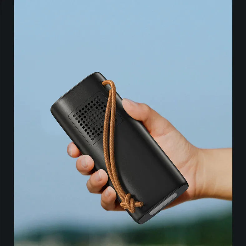 Black portable power bank with 20000mAh capacity and solar panel for emergency outdoor charging.