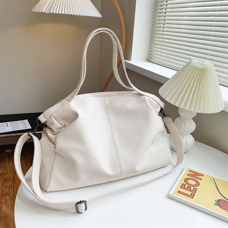 Large soft black PU messenger tote bag with car suture detailing and a long shoulder strap