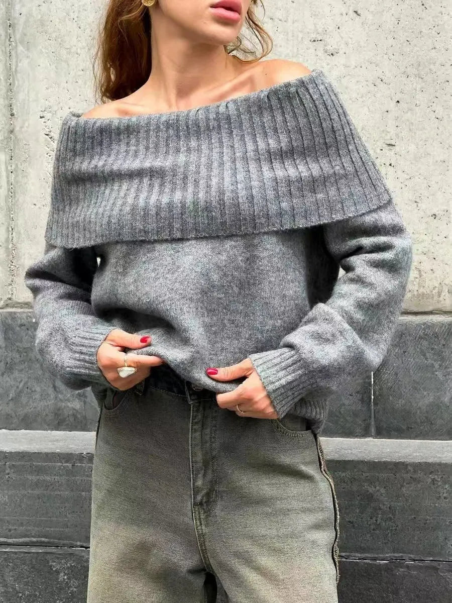 Grey off-the-shoulder strapless sweater with a 3D textured pattern and regular sleeves.
