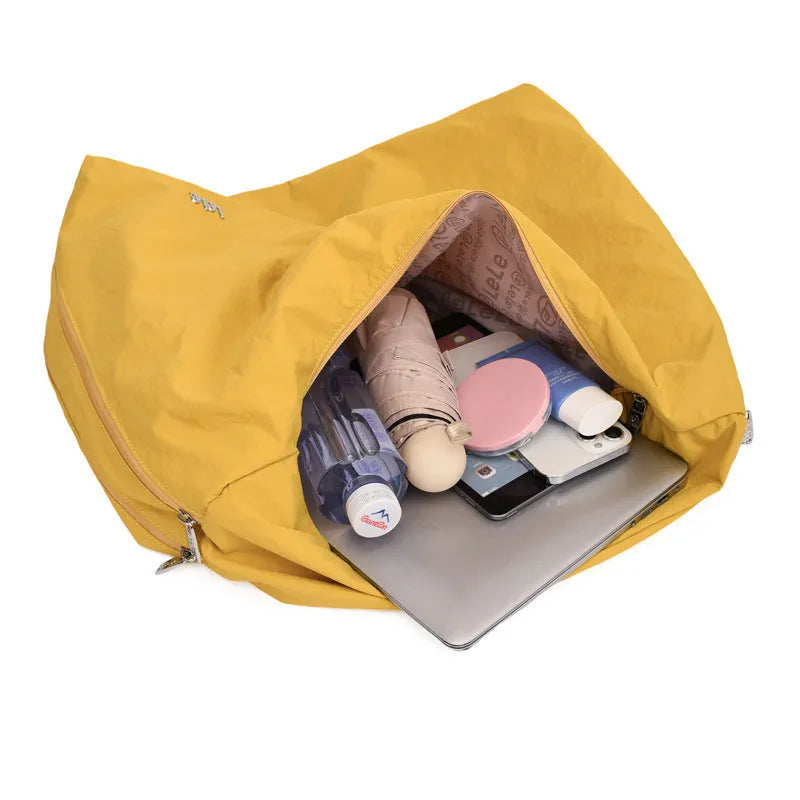 Nylon underarm bag with heart shape design in four colour options showing large capacity interior