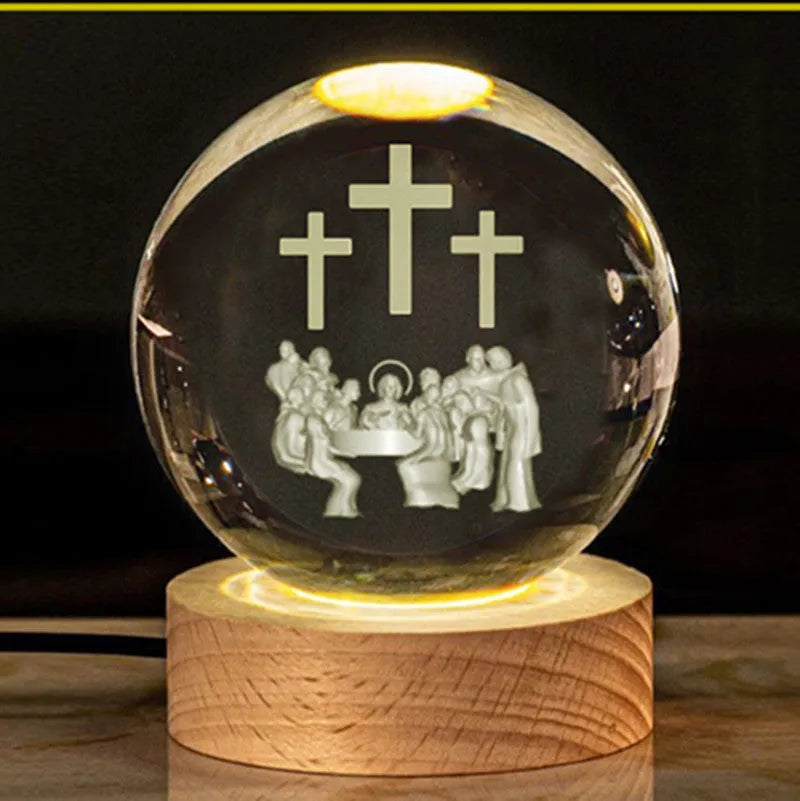 White crystal ball ornament on wood base with warm light and religious symbols