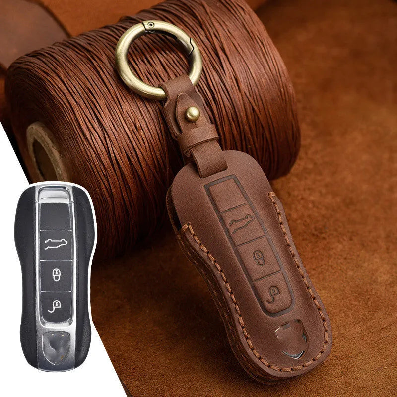 Brown leather Porsche key case with retro bag buckle holding three car keys