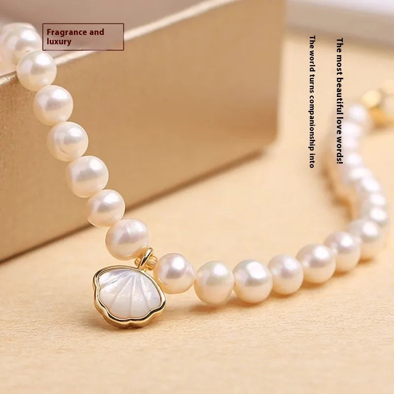 Women's freshwater pearl bracelet with fan-shaped alloy clasp, shown with both elastic and chain fastening options.