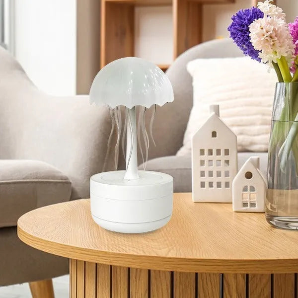 White jellyfish-shaped desktop humidifier and essential oil diffuser with colourful night light on.