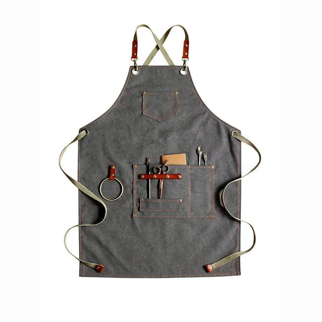 Canvas cross strap apron in camel colour shown from the front.