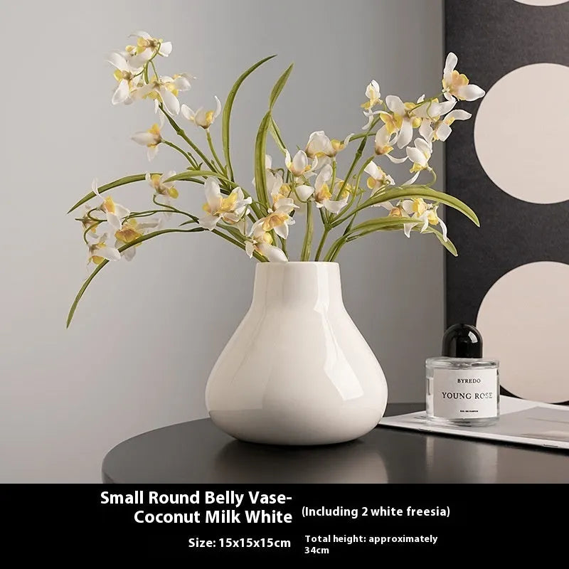 Ceramic decorative vase with coloured glaze surface and artificial orchid flowers in black or white colour