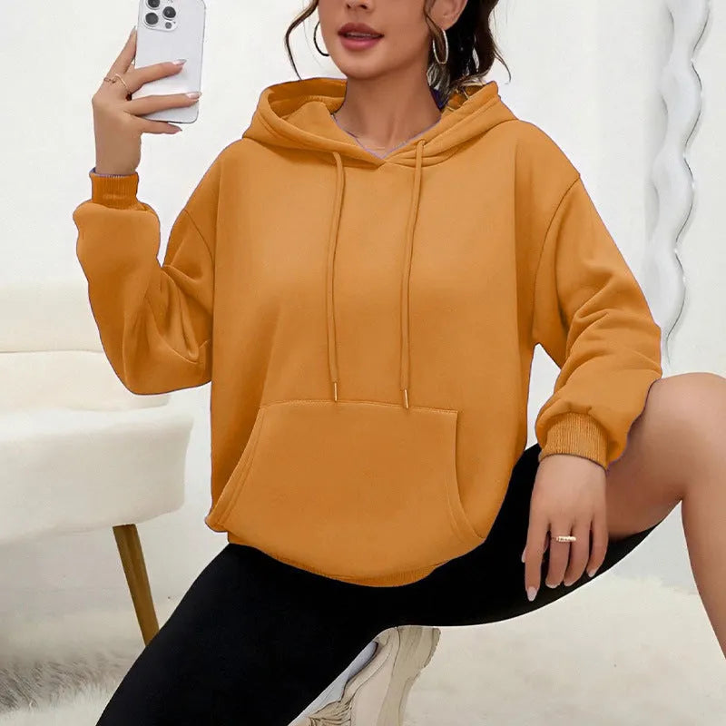 Women's loose grey drawstring pocket sweatshirt with long sleeves on a hanger.