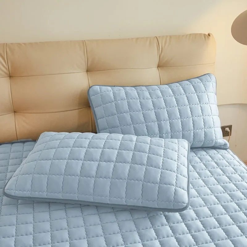Blue waterproof fitted sheet with elasticated corner on a mattress