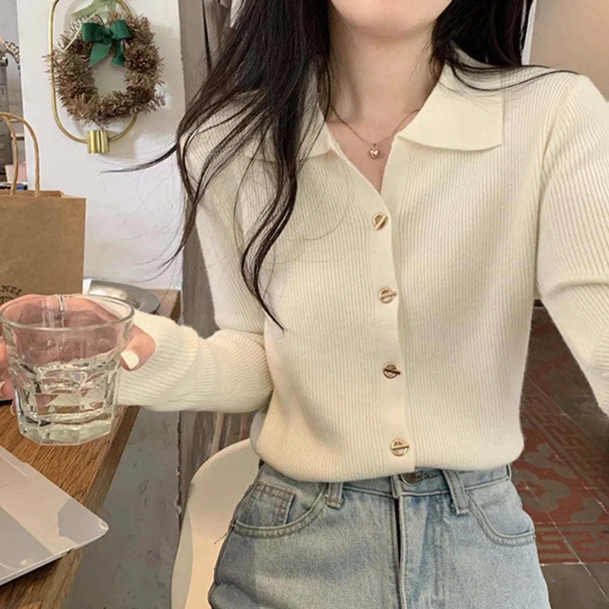 Long-sleeved loose knitted cardigan top in viscose fibre, shown in a neutral colour on a hanger.