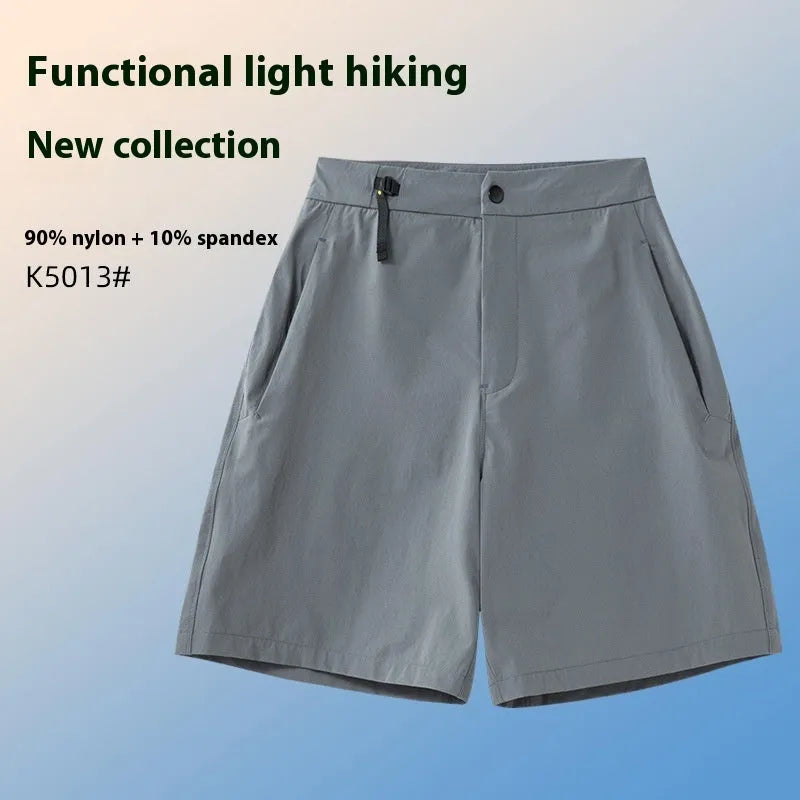 Men's solid colour quick-dry sports shorts with elastic waistband on a grey background.