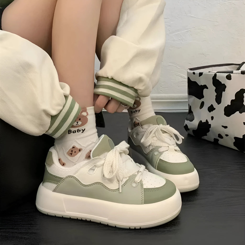 Green women's casual lace-up shoes with PU mesh upper and flat heel on a white background.
