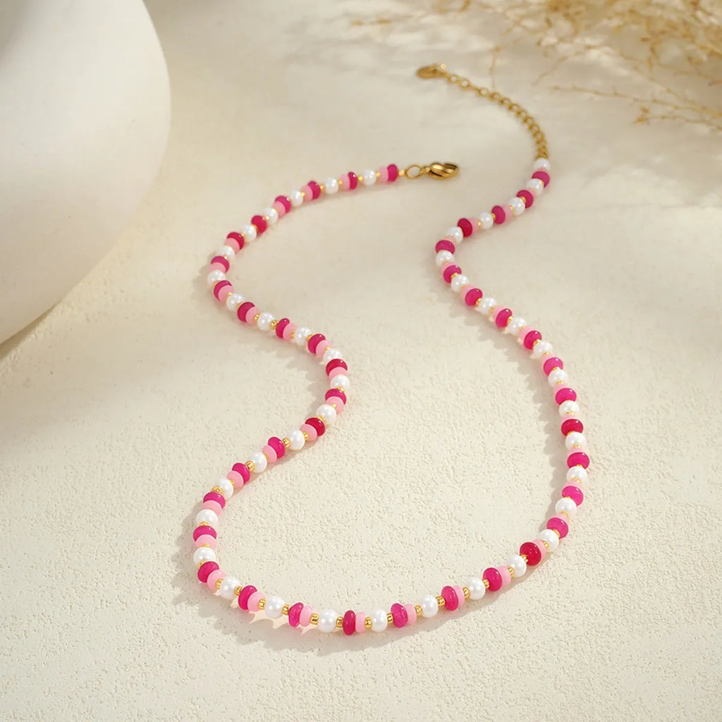 18K gold plated stainless steel chain necklace with pink electroplated resin bead pendant on white background
