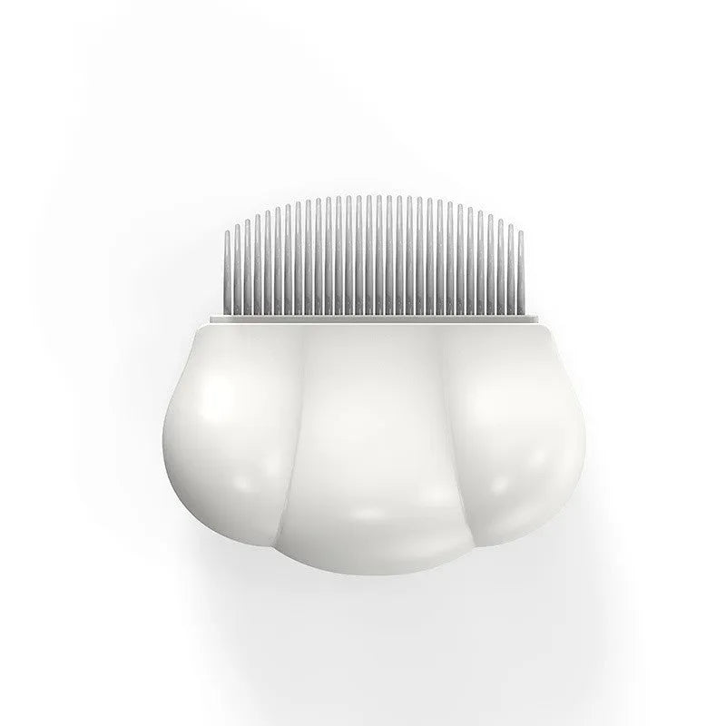 Paw Soft deshedding brush grooming tool for cats and dogs on a white surface.
