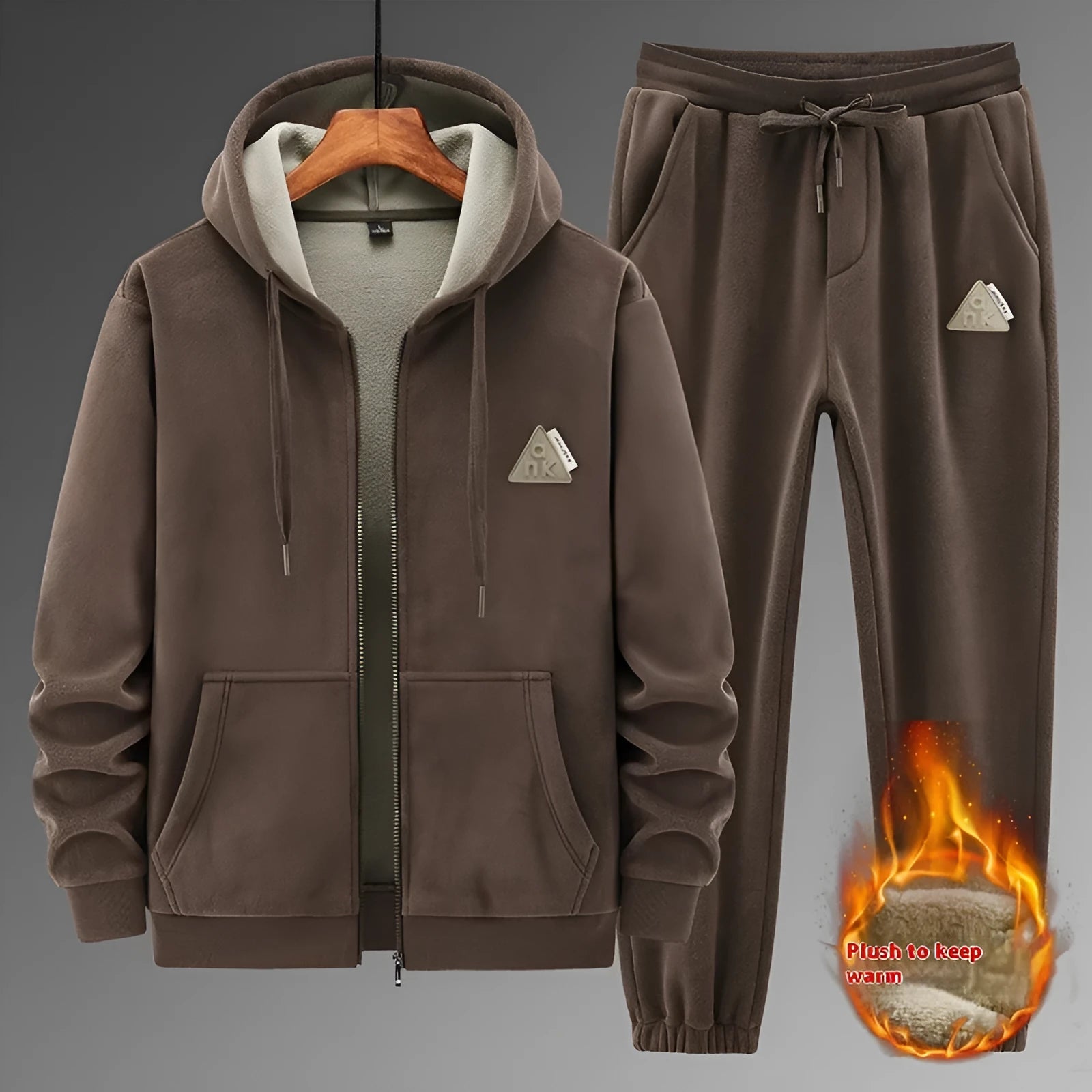 Man wearing a grey hooded zip-up sports jacket and matching trousers from a casual sports suit set.