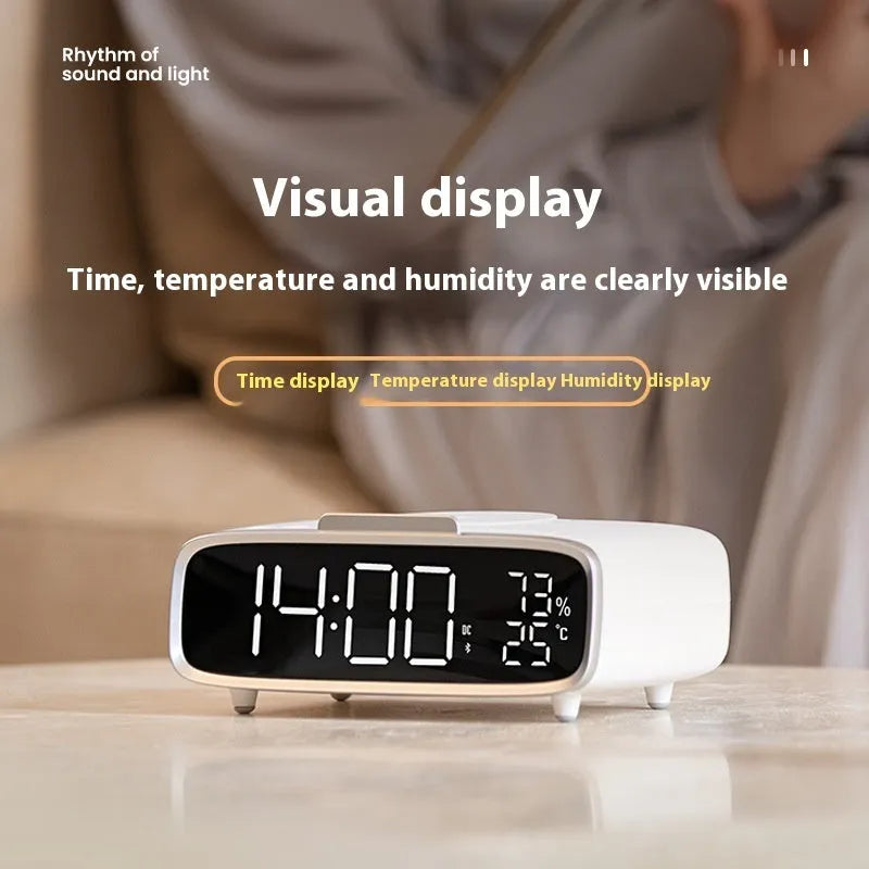 White ABS acrylic Bluetooth speaker wireless charging night lamp on a surface.
