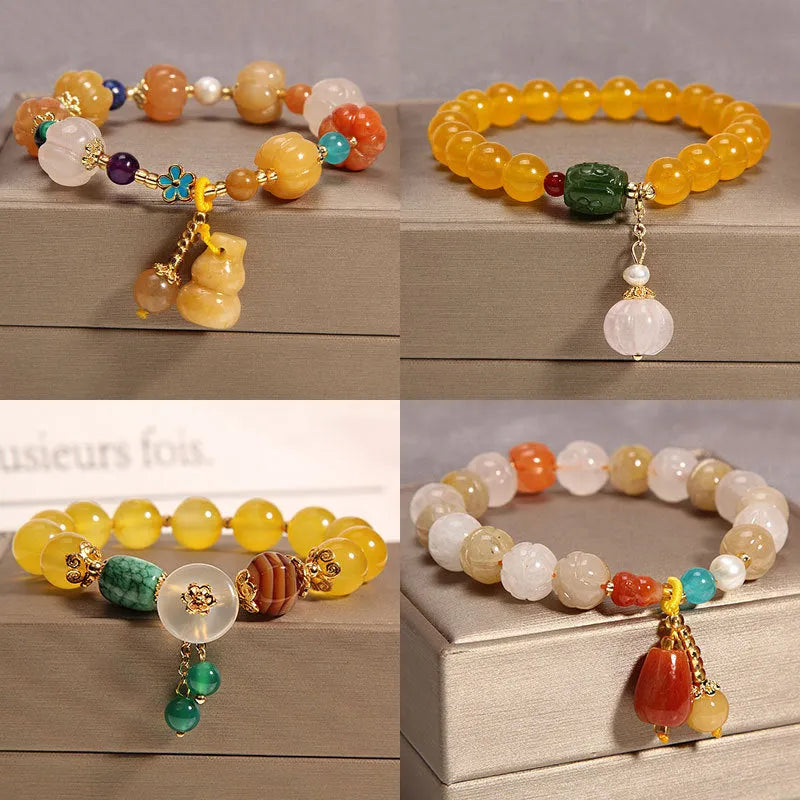 Yellow agate crystal bracelet with gold silk adjustable cord on a wrist, showing khaki coloured beads.