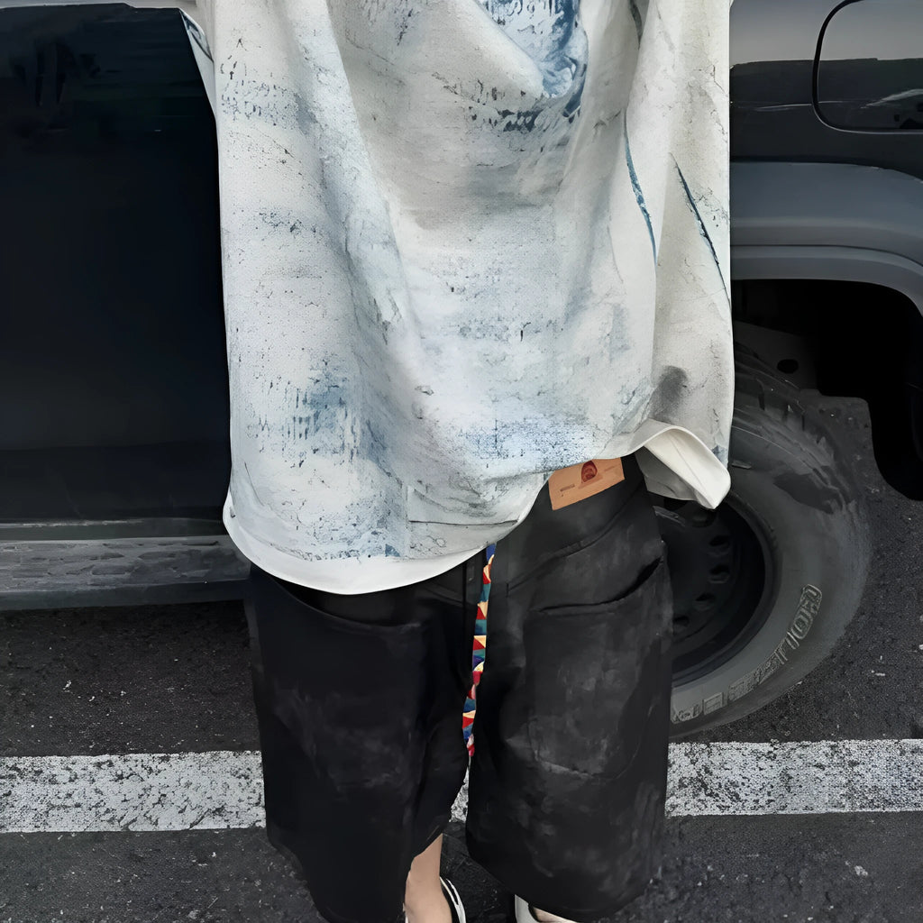 Korean style loose fit T-shirt with a full printed tie dye design on a solid colour background.