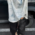 Korean style loose fit T-shirt with a full printed tie dye design on a solid colour background.