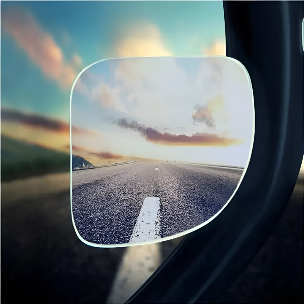 A pair of small, fan-shaped white glass blind spot mirrors for cars, showing 360-degree adjustable mounting.