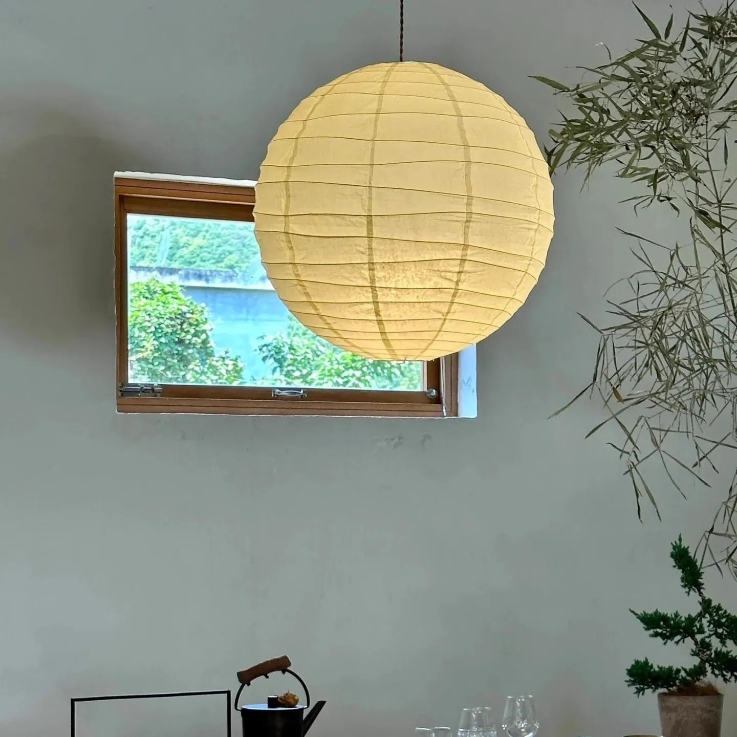 Japanese style rice paper ceiling chandelier lamp with a natural shade in a living room setting.