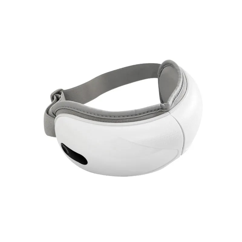 White rechargeable eye massager with heat and air compression therapy on a grey background.