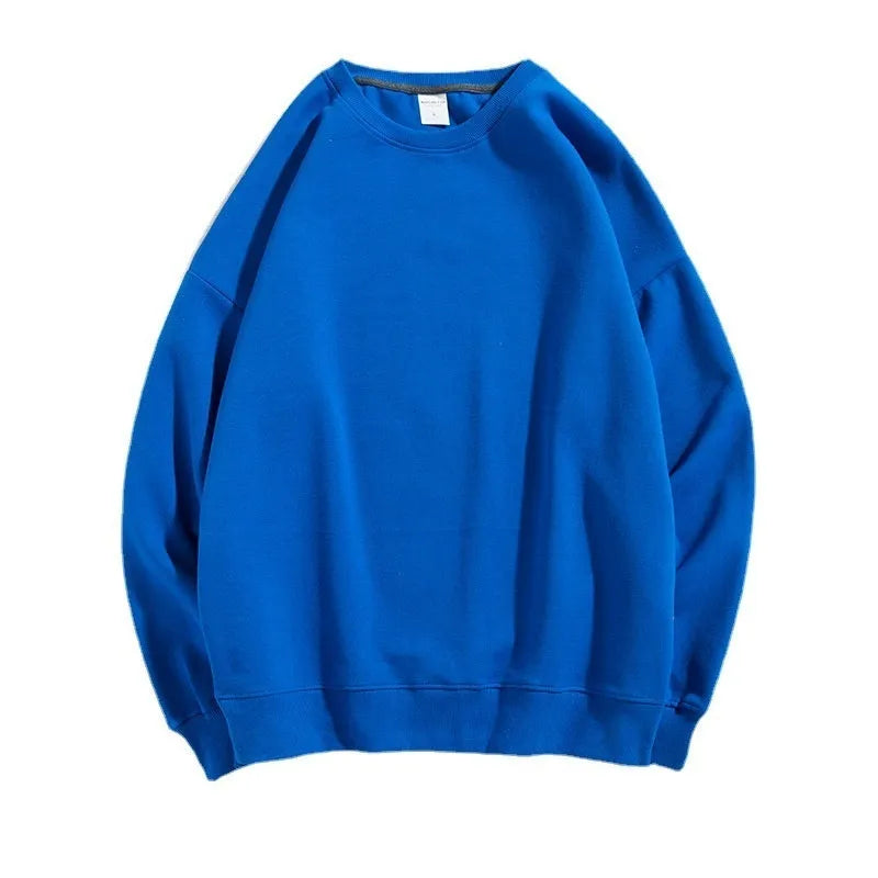 A loose-fitting, off-shoulder cotton sweater in a solid colour with long sleeves and a round neck.