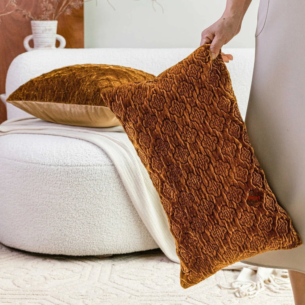 Brown gold antique style three-dimensional quilted cushion pillow on a sofa.