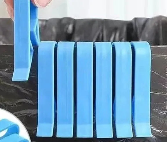 White PP plastic non-slip clip holding a black bin liner to the side of a silver kitchen trash can.