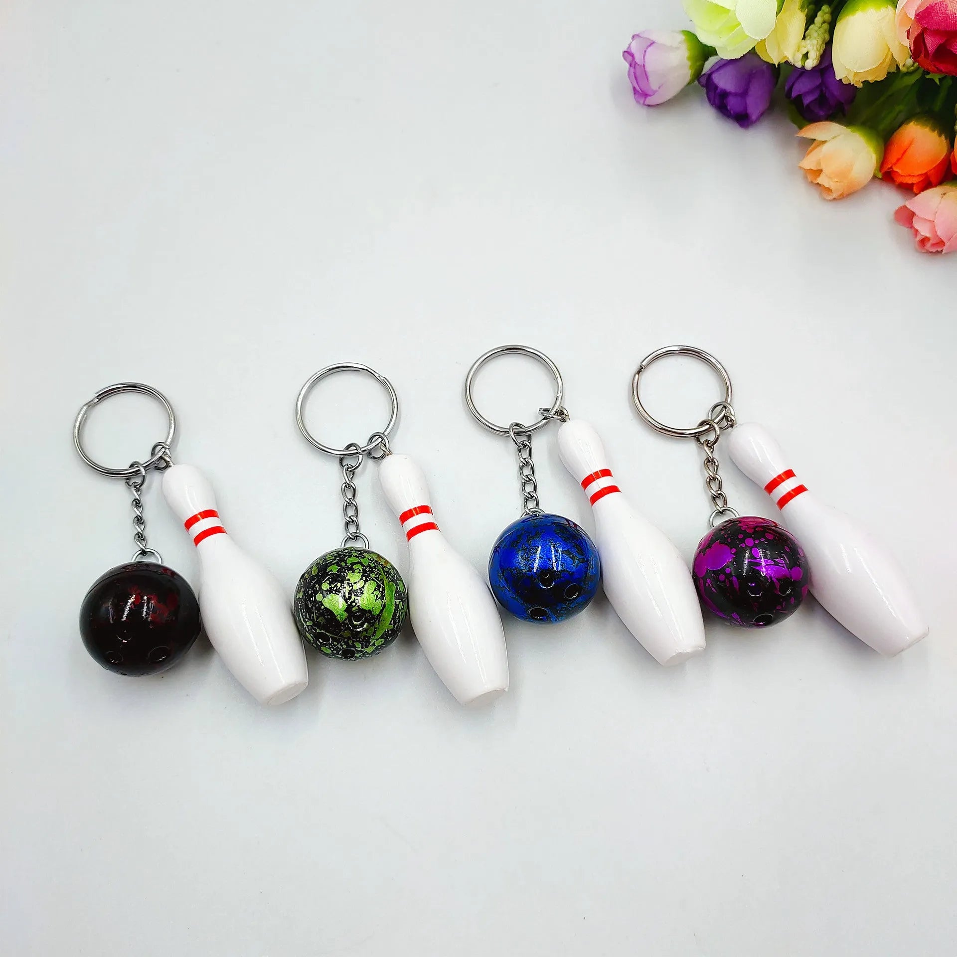 Mini simulation sports bowling pin keychain pendant in blue, dark red, green, or purple colour options.