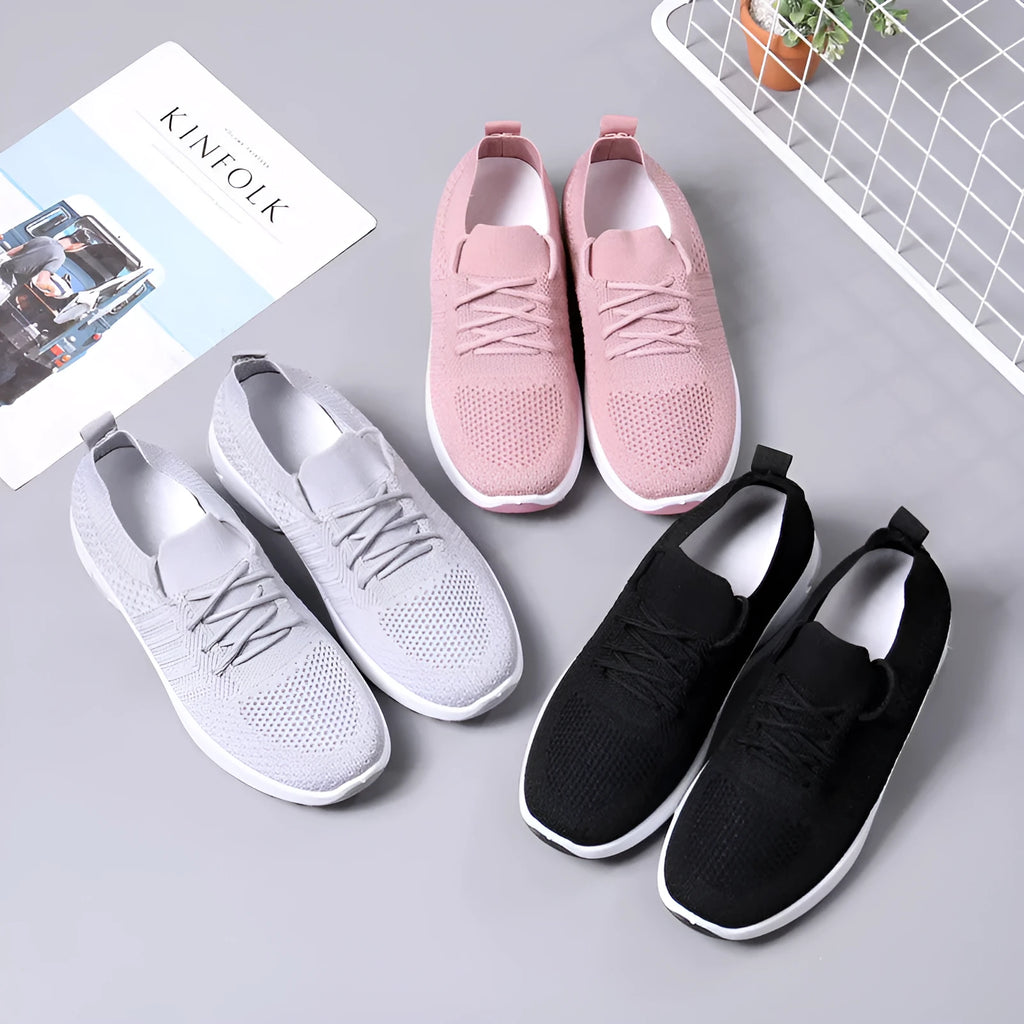 Women's black mesh sneaker with lace-up front and round toe on a non-slip PVC sole.