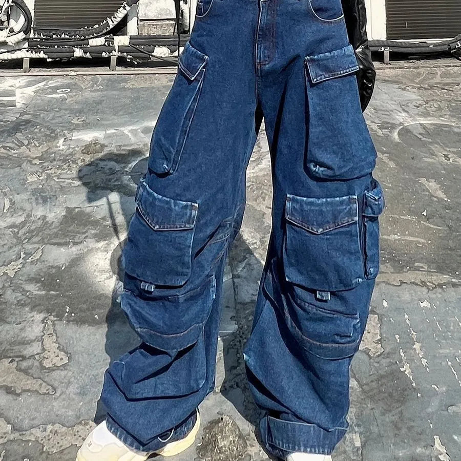 Dark blue distressed wide-leg high-waist jeans with multiple pockets on a denim background.