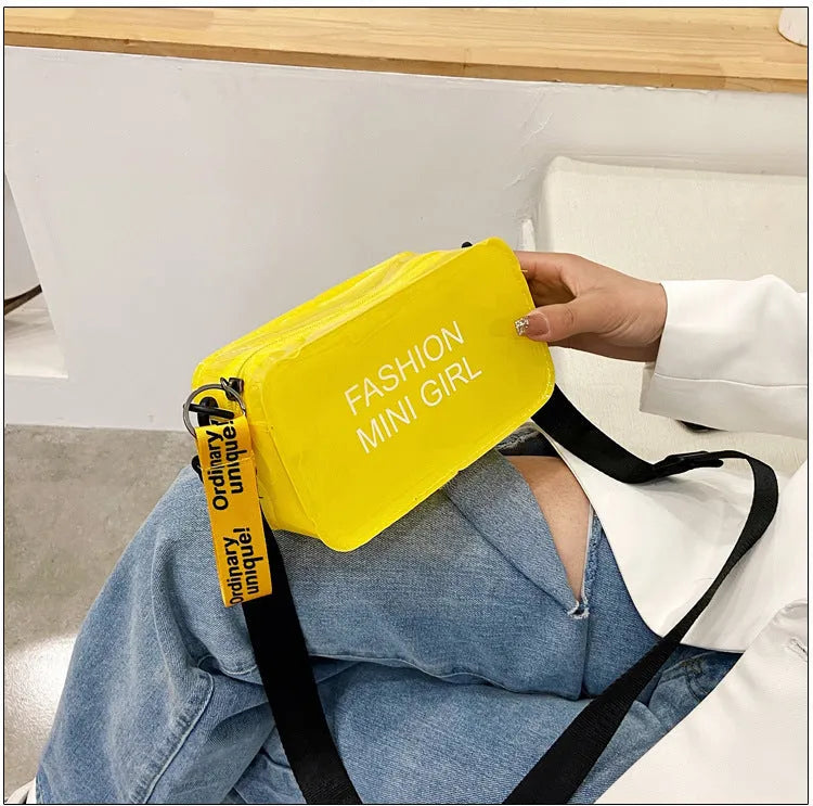 Transparent square women's shoulder bag in jelly material with a diagonal cross strap, showing internal mobile phone pocket.