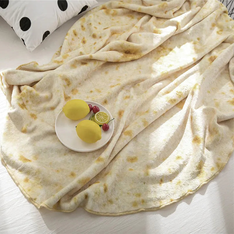 Round coral fleece flannel blanket rolled in a burrito style, showing soft texture and printed design.