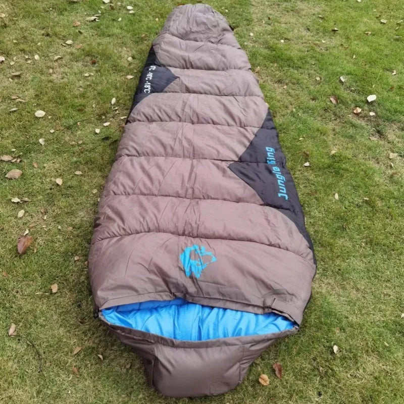 Outdoor cotton sleeping bag in Army Green with its compression sack, sized 230cm long.