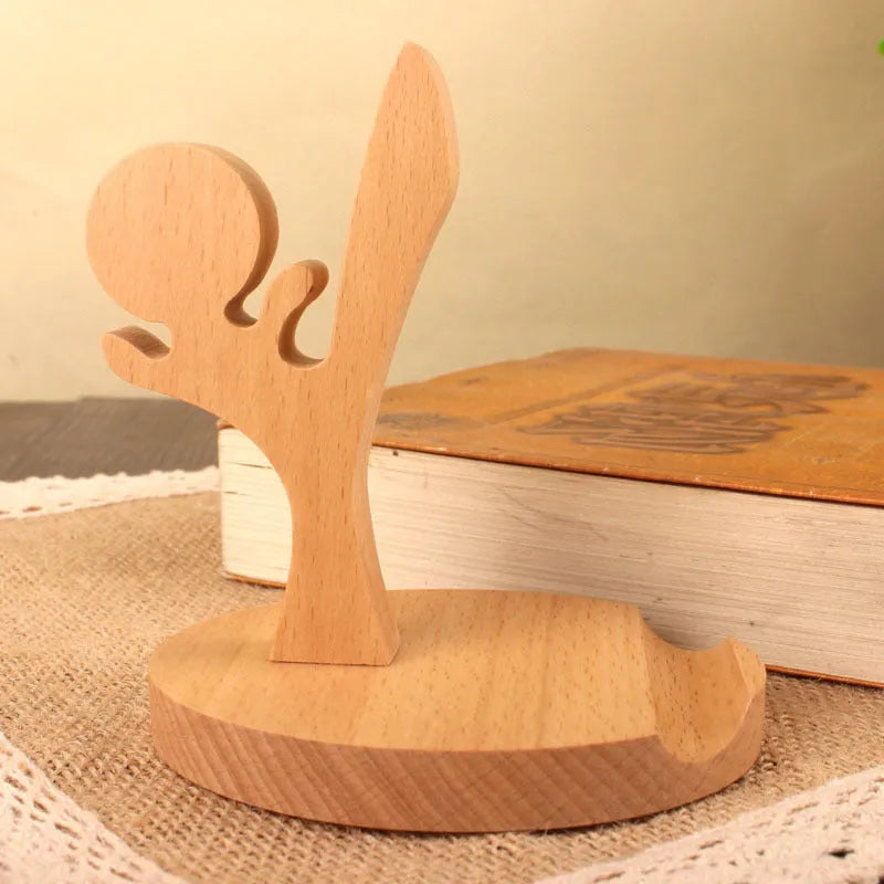 Beech wood mobile phone holder stand with coin slot and decorative carving.