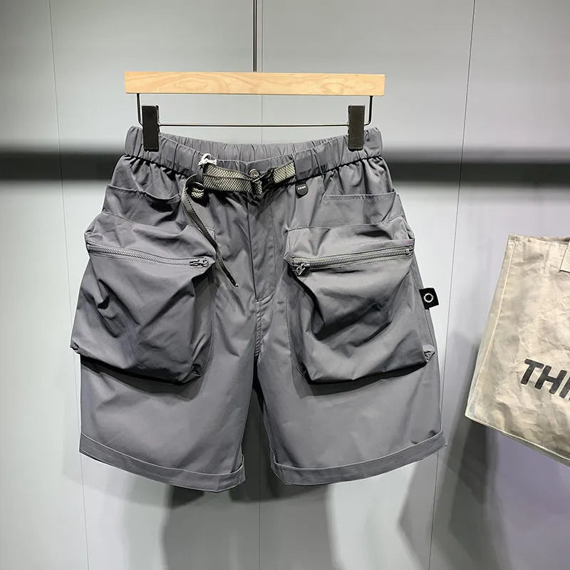 Men's loose-fitting black workwear shorts with pockets, featuring a non-iron finish and a mid-waist design.