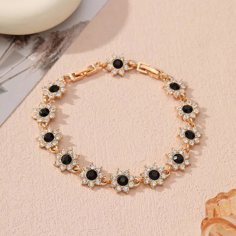 Floral zinc alloy bracelet with electroplated gold or silver finish and gemstone colour variants