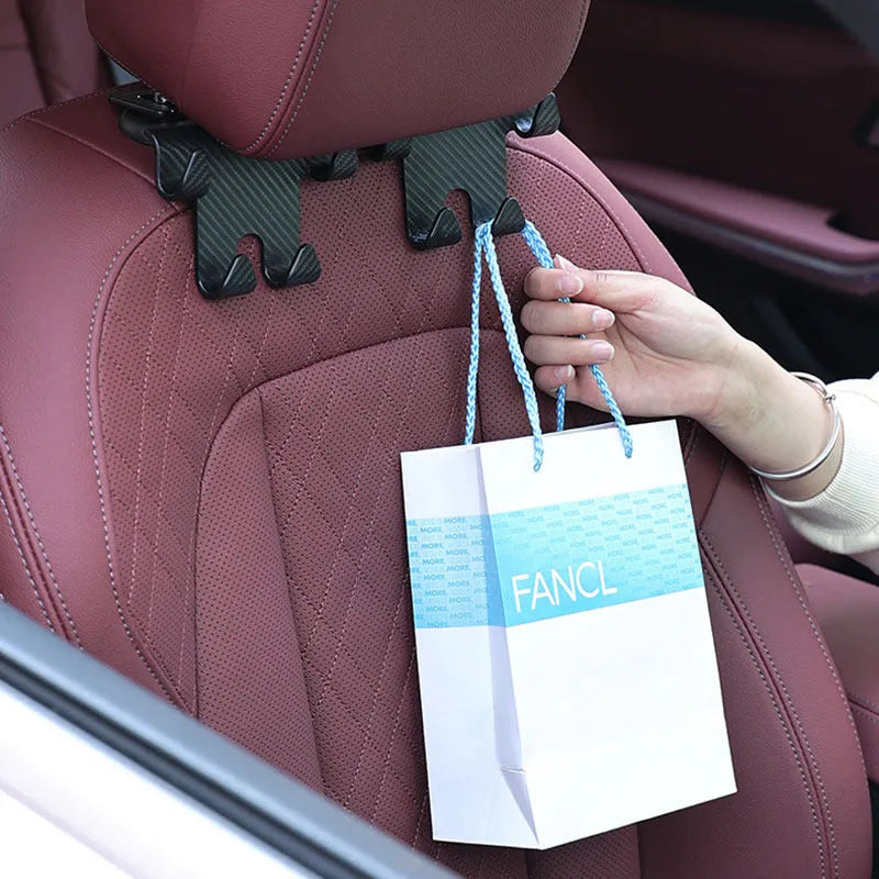 Black ABS plastic car hook with integrated mobile phone holder bracket for rear seat backs.