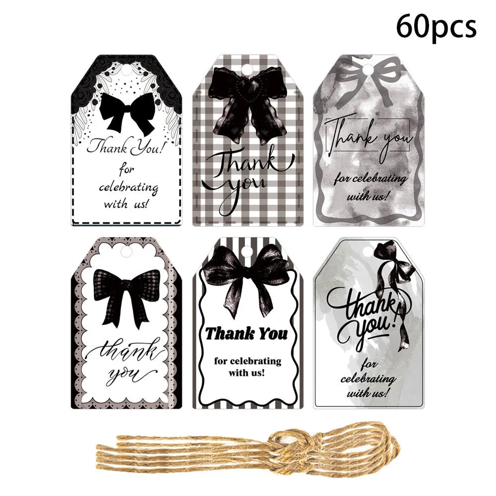 Set of 60 bowknot-shaped paper gift tags with natural hemp rope for birthday parties in three styles.