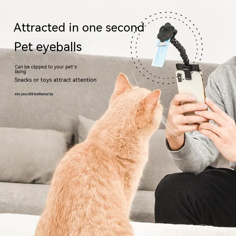 Black pet photography tool holding a mobile phone and a dog treat, on a white background.